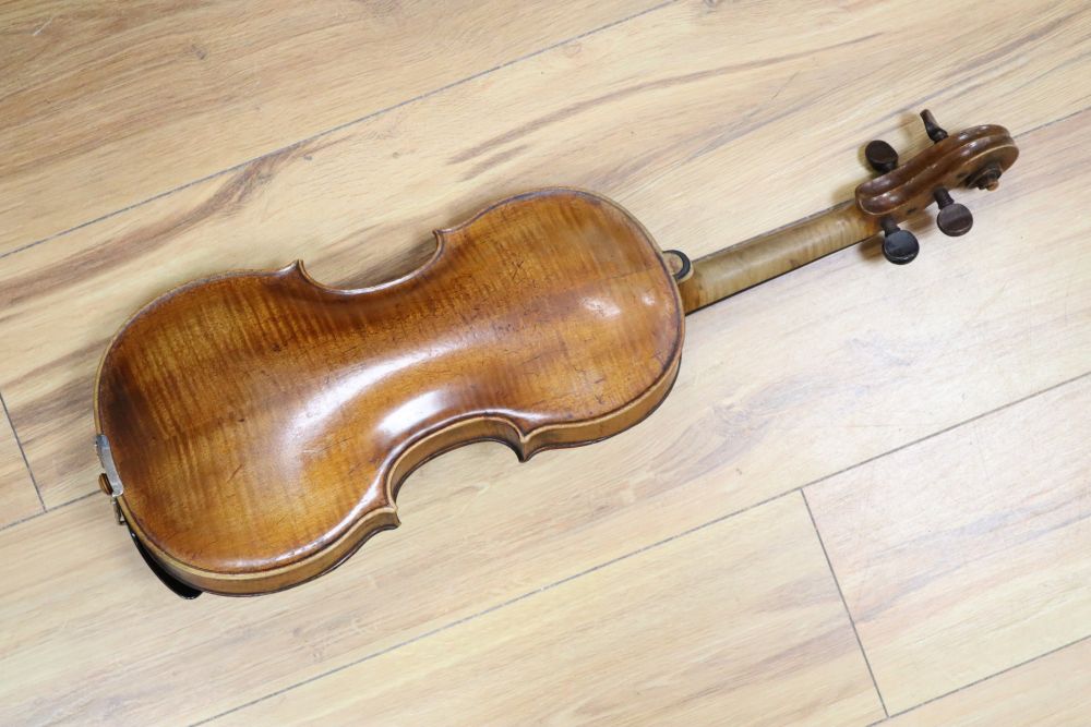 A cased violin with two bows. Violin bears the label Carl Willhelm Claesel, circa late 18th century/early 19th century, 35.5cm back in